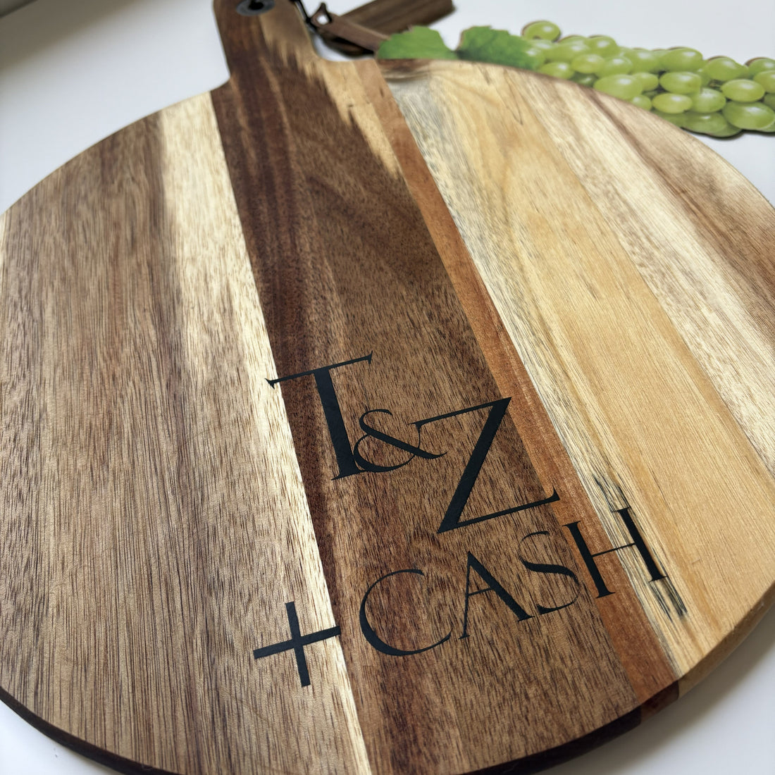 Acacia wood cutting serving board with black epoxy resin filled engraving T & Z Cash