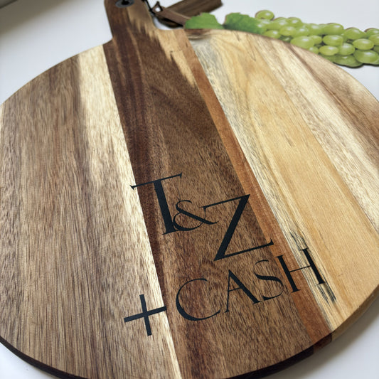 Acacia wood cutting serving board with black epoxy resin filled engraving T & Z Cash