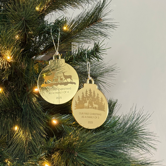 Gold Christmas ornaments on a decorated tree with lights.
